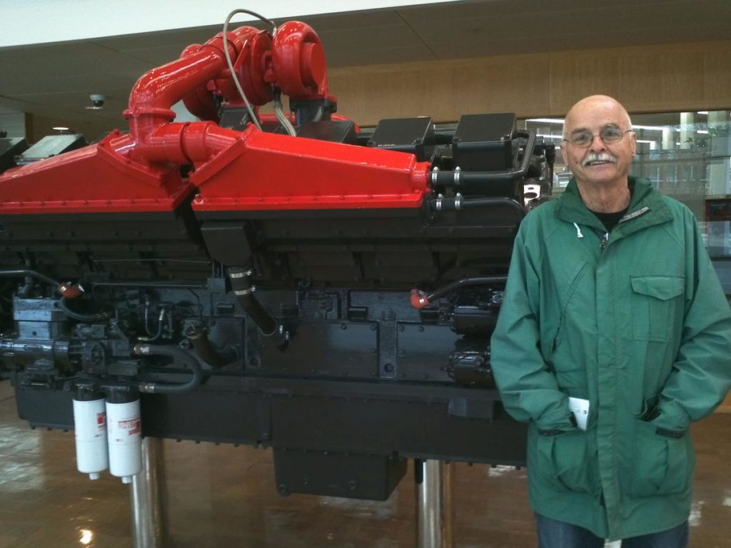 Al Bates with large piece of machinery